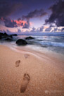 Footprints lead to the surf. Kauai, Hawaii.